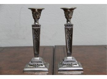 A Pair Of Candlesticks With Silver Detail