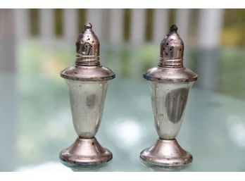 A Pair Of Sterling Silver Weighted Salt And Pepper Shakers