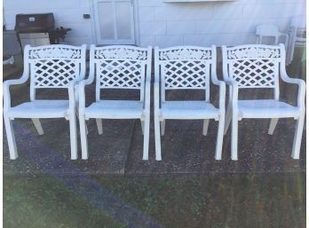 Four White Outdoor Chairs With Rose Lattice