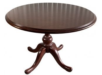A Queen Ann Style Round Oak Pedestal Dining Table