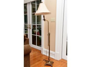A Brass Floor Lamp With Drop Bead Shade