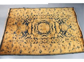 A Black And Gold Wool Rug From India