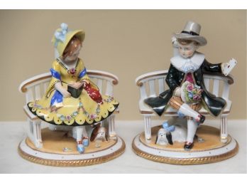 An Antique Pair Of Porcelain Boy And Girl Candle Holders