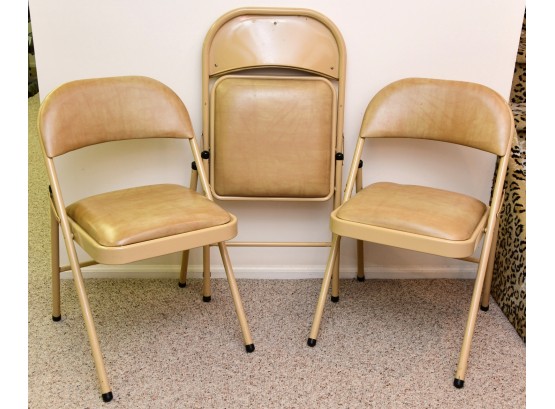 A Set Of 4 Cushioned Folding Chairs