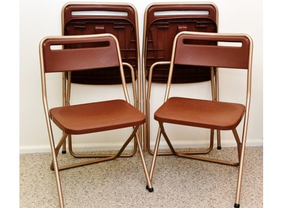 A Set Of 4 Folding Chairs