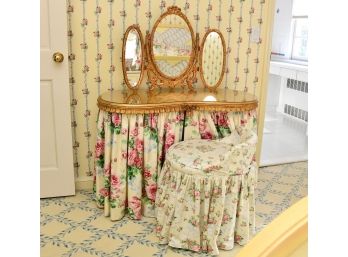 A Kidney Shaped Vanity Table With Mirror And Chair