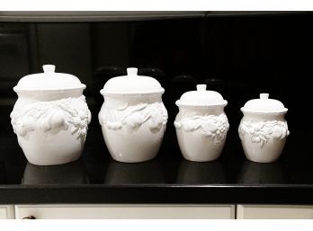 Four White Ceramic Floral Canisters