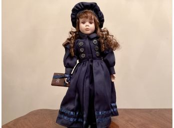 Collectors Doll With Blue Velvet Outfit Holding A Bear