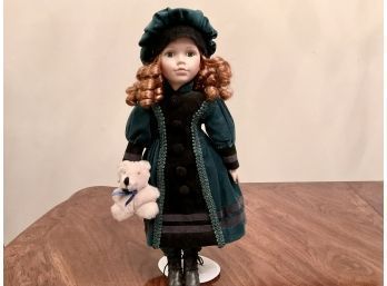 Collectors Doll With Green Velvet Dress Holding A Bear