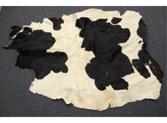 A Black And White Cowhide Rug