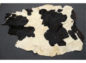 A Black And White Cowhide Rug