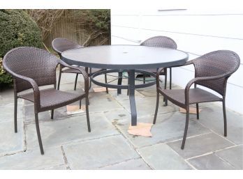 Round Outdoor Patio Table With Four Brown Wicker Chairs