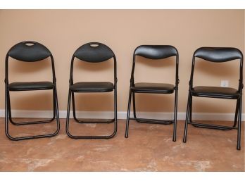 Four Black Folding Chairs