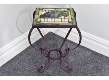 Bent Metal Accent Table With Grapes On The Tabletop