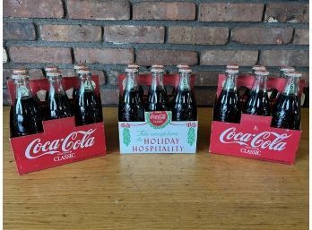 Three Packs Of Six Vintage Holiday Coke Bottles
