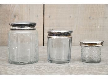Trio Of Decorative Glass Jars With Silver Lids