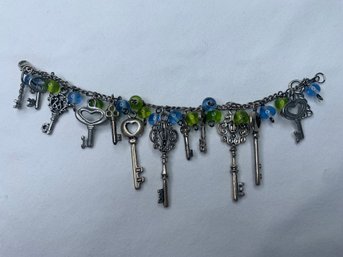 Skeleton Key Themed Fashion Bracelet, Silver Toned Chain And Ornate Keys With Blue And Green Glass Beads