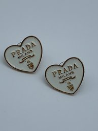 Heart Shaped Gold Toned And  White Enamel Post Back Earrings In The Style Of Prada With Logo, 7/8-Inch