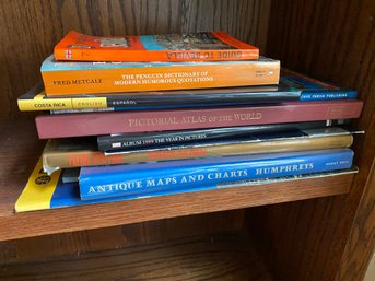 Stack Of Atlas, Maps, And Other Books.