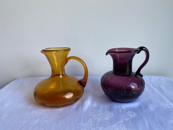 Pair Of Purple & Amber Glass Pitchers