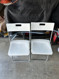 2 White Folding Chairs