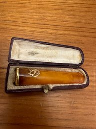 Old Amber Cigarette Smoker & Gold Badge