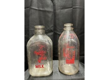 Two Antique Advertising Milk Bottles