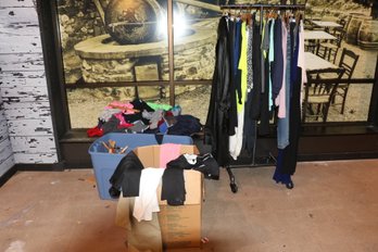 Large Group Of Mixed Clothes On Floor And Rack