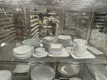 Large Group Of Plates On Shelf