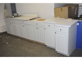 Assorted Matching Base Cabinets With Counter Top Section Containing Sink.