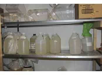 Contents Of Shelf.  Gallon Sized Containers Of Soap Making Supplies