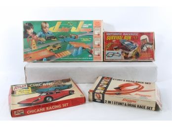 Four  Vintage Toy Racing Sets