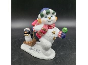 Snowman Pulling Penguin On Sled Figurine, Trimmed In Gold Accents