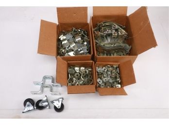 Assorted Straps, Brackets, And Fasteners, Also 3 Fixed Wheels