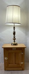 White Clad End Table And Brass Lamp