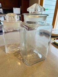 Two Tall Glass Canisters