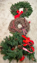 Two Christmas Wreaths And A Garland