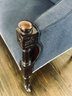 Antique Custom Fabric Navy Loveseat With Brass Nailhead Detail On Dark Wood Legs With Wheels