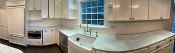 High Gloss, Painted White Cabinets With Sub-Zero Built In Fridge & Marble Countertops